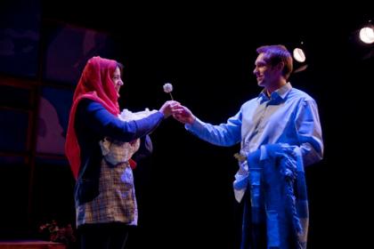 Anisah (Carolyn Marie Monro) and Bo (Kevin Pitman) share a dandelion. Taproot Theatre Co. Seattle, WA. Photo by Erik Stuhaug